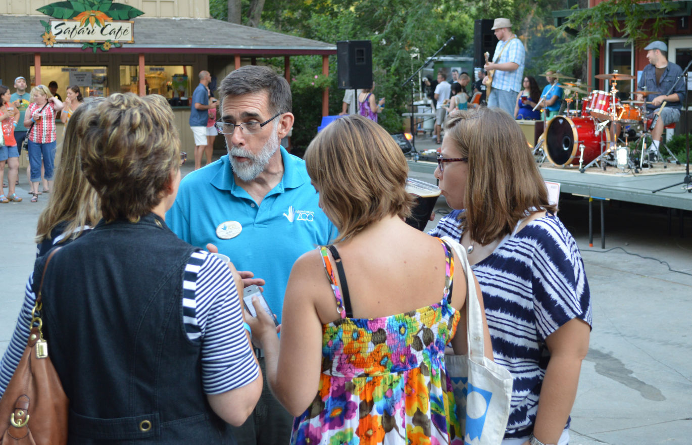 John Chapo visits with guests, band plays in background